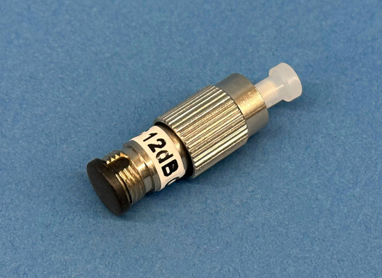Close-up of a plug type singlemode 12dB fixed fiber optic attenuator at 1300/1550nm with male to female FC/Ultra PC connectors